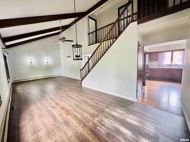 unfurnished living room with a sink, ceiling fan, beamed ceiling, wood finished floors, and a baseboard radiator