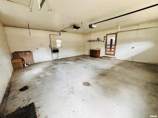 garage featuring heating unit and a garage door opener