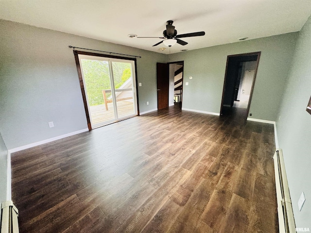 empty room with baseboard heating, ceiling fan, baseboards, and wood finished floors