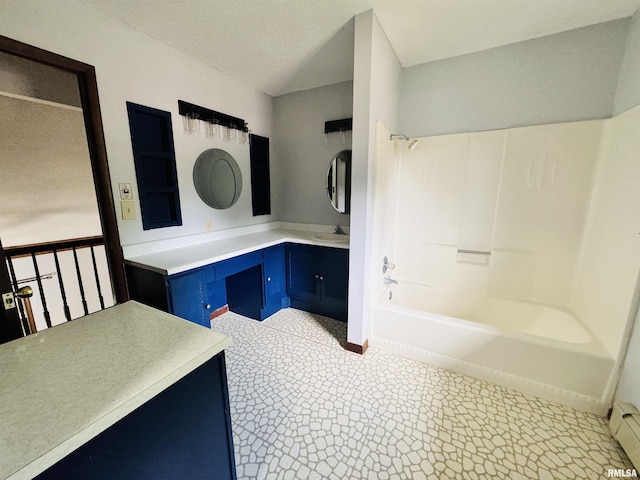 bathroom with vanity and shower / washtub combination