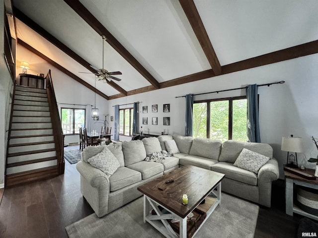 living room featuring stairs, beamed ceiling, dark wood finished floors, and high vaulted ceiling