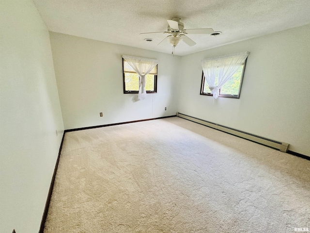 carpeted empty room with a ceiling fan, baseboards, visible vents, a textured ceiling, and a baseboard heating unit