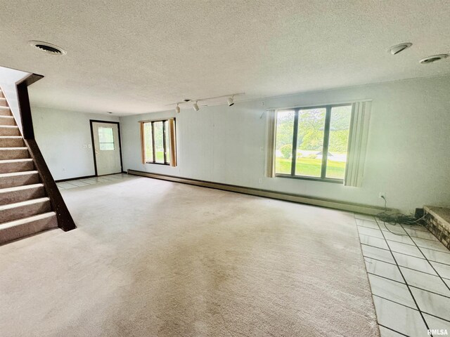 unfurnished living room featuring a wealth of natural light, carpet flooring, stairs, and visible vents