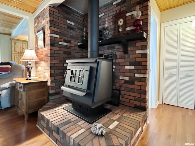 room details featuring wood ceiling, hardwood / wood-style flooring, and a wood stove