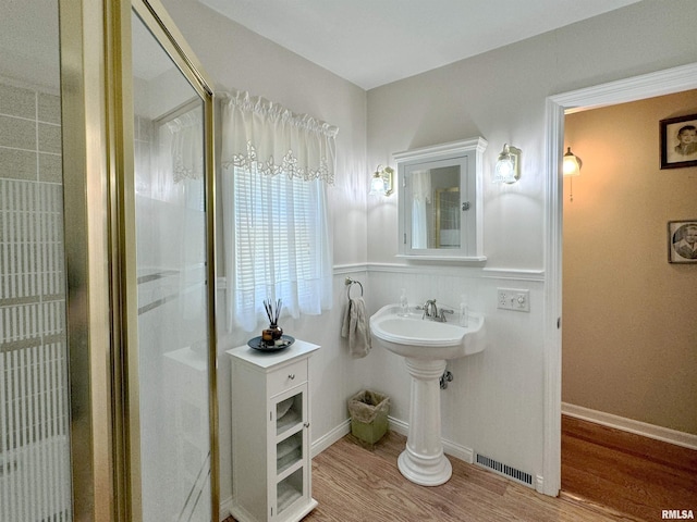 bathroom with wood-type flooring