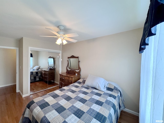 bedroom with a closet, ceiling fan, and dark hardwood / wood-style floors