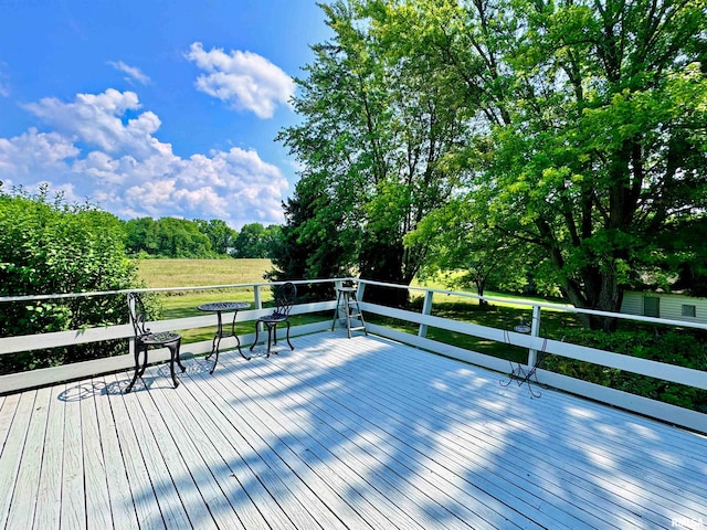 wooden terrace featuring a rural view