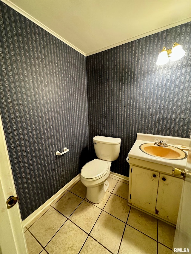 bathroom featuring toilet, tile patterned flooring, crown molding, and vanity