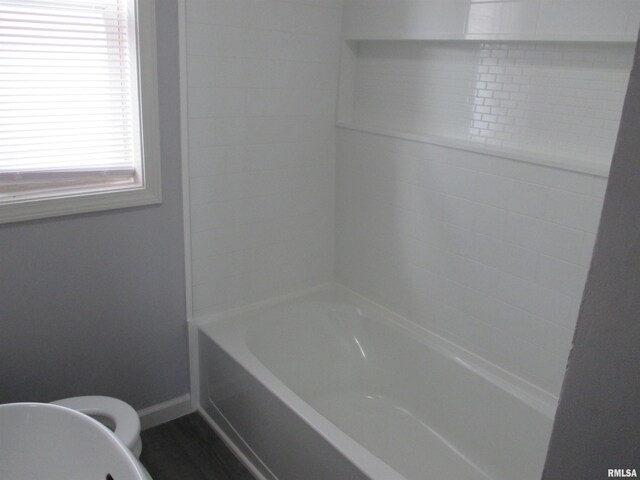 bathroom featuring toilet and shower / washtub combination