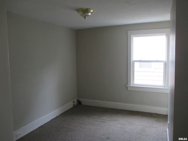 empty room featuring carpet flooring and plenty of natural light