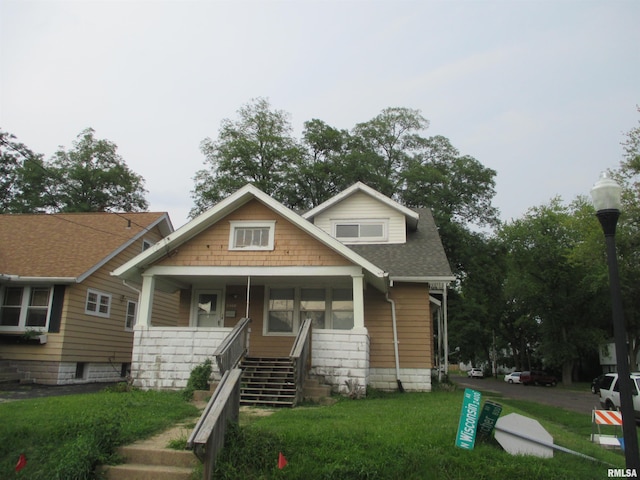 view of front of home with a front lawn and a porch