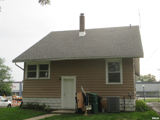 back of house featuring cooling unit