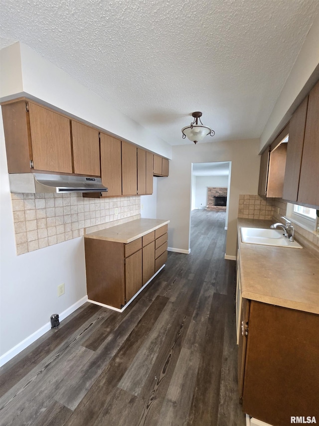 1638 Knox Highway 15, Dahinda, IL 61428 - kitchen with a sink, under cabinet range hood, dark wood-style floors, tasteful backsplash, and a textured ceiling