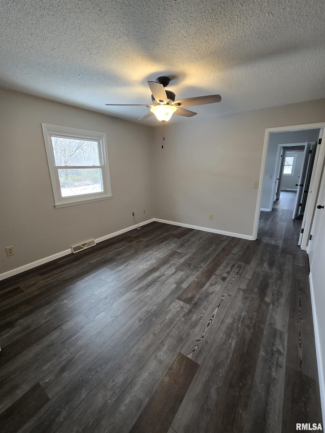 1638 Knox Highway 15, Dahinda, IL 61428 - spare room featuring a ceiling fan, dark wood finished floors, baseboards, and a textured ceiling