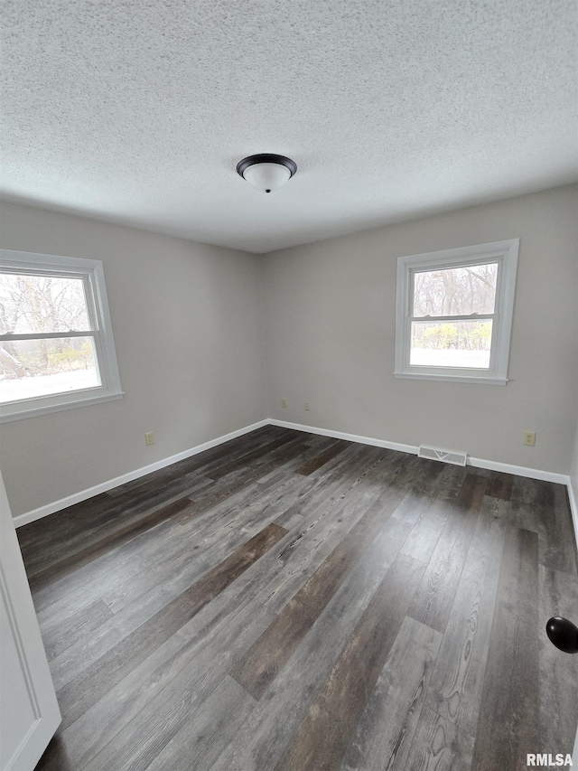 1638 Knox Highway 15, Dahinda, IL 61428 - unfurnished room featuring dark wood-style floors, baseboards, and a textured ceiling