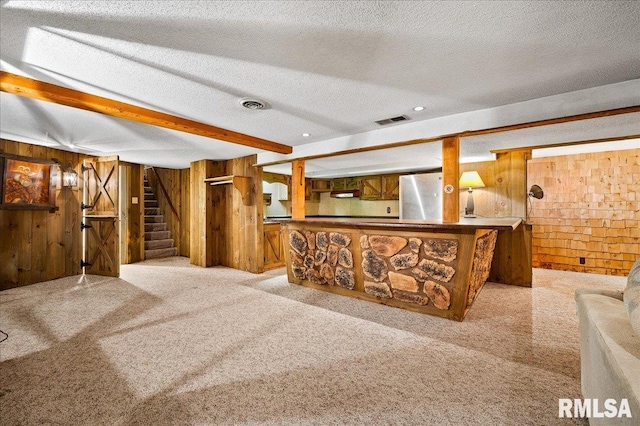 1638 Knox Highway 15, Dahinda, IL 61428 - living area featuring wooden walls, bar with sink, stairs, light colored carpet, and a textured ceiling