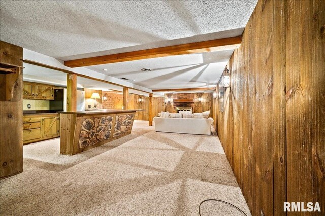 1638 Knox Highway 15, Dahinda, IL 61428 - unfurnished living room with wooden walls, beamed ceiling, light carpet, and a textured ceiling