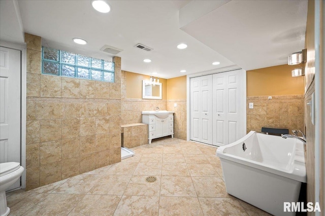 1638 Knox Highway 15, Dahinda, IL 61428 - bathroom featuring tile walls, vanity, a freestanding tub, toilet, and recessed lighting