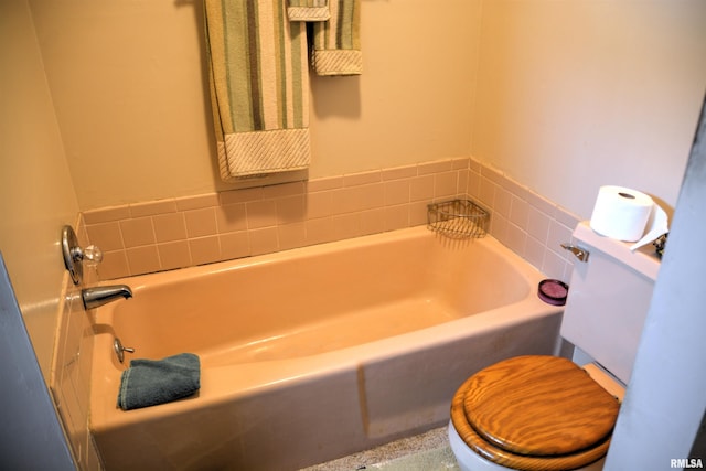 bathroom featuring a bathing tub and toilet