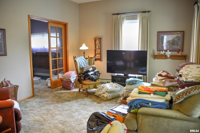 carpeted living room with baseboard heating