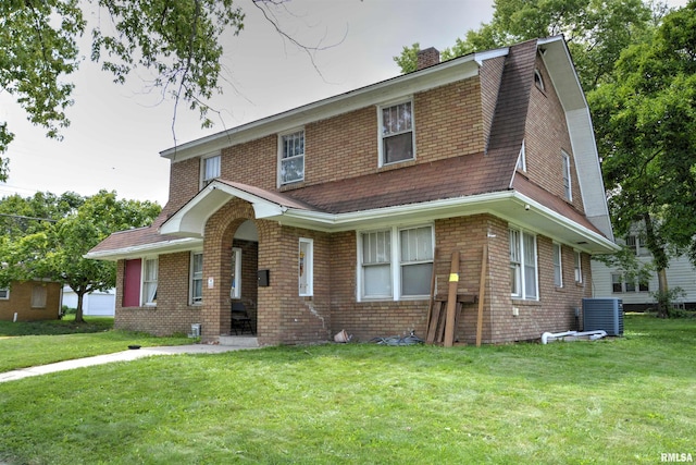 view of front of home with a front lawn and central air condition unit