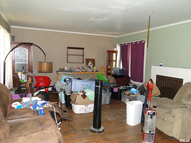 324 N Charles St, Macomb, IL 61455 - living area with wood-type flooring, crown molding, and a fireplace