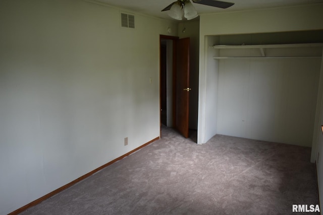 unfurnished bedroom with carpet, a closet, and ceiling fan