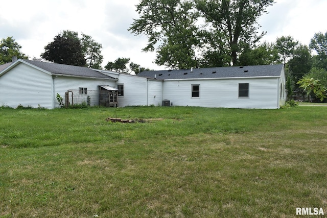 rear view of property with a yard