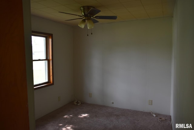 carpeted empty room featuring a healthy amount of sunlight and ceiling fan