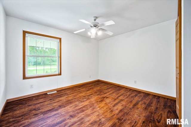 spare room with hardwood / wood-style flooring and ceiling fan