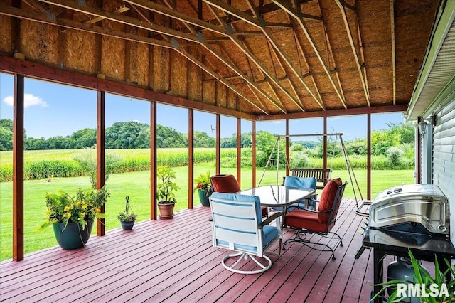 sunroom / solarium featuring vaulted ceiling