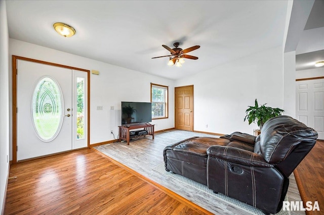 living room featuring hardwood / wood-style floors and ceiling fan