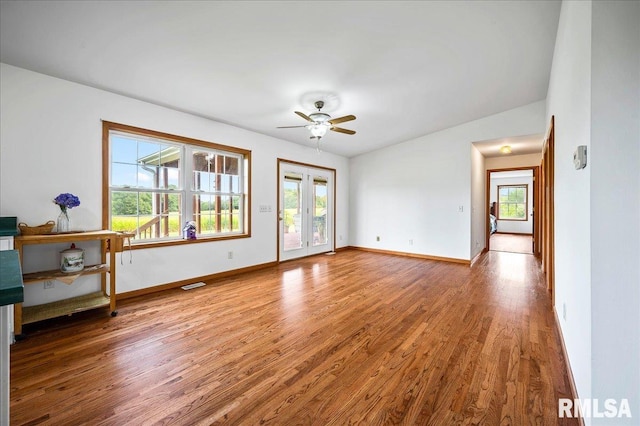 interior space featuring lofted ceiling, hardwood / wood-style floors, ceiling fan, and french doors