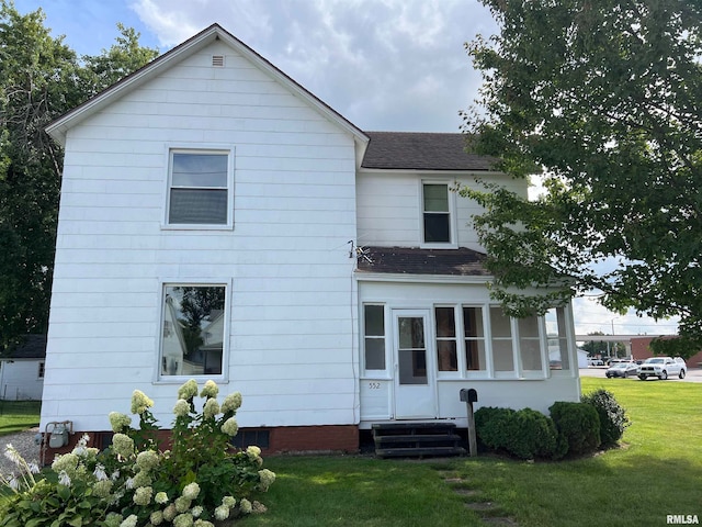 rear view of house with a lawn