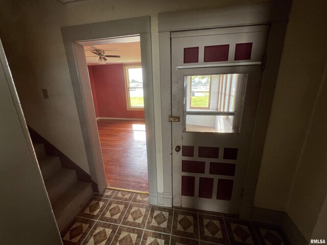 doorway to outside featuring dark tile patterned flooring