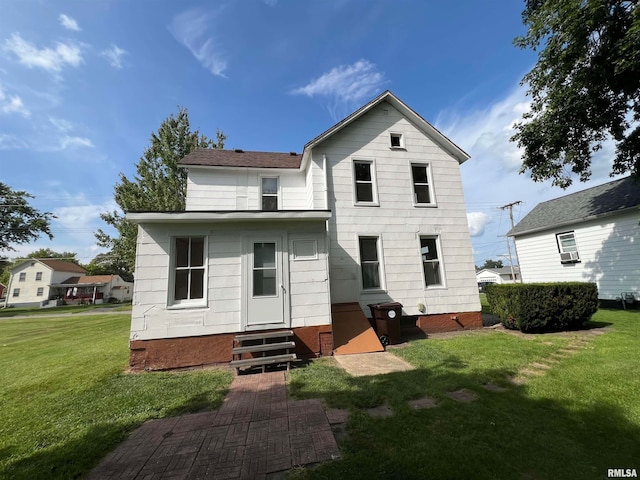 rear view of property with a yard