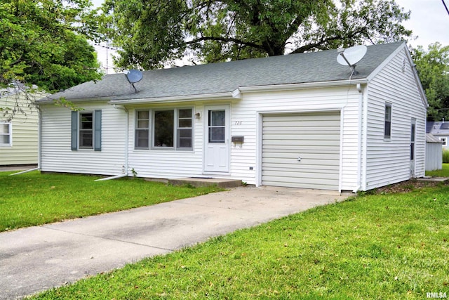 view of front of property with a garage and a front lawn