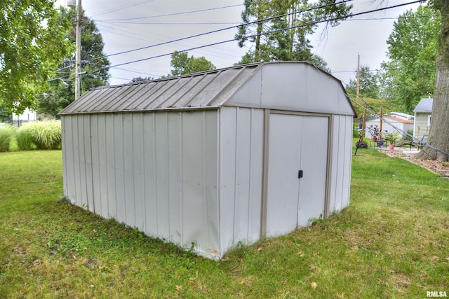 view of outdoor structure featuring a lawn