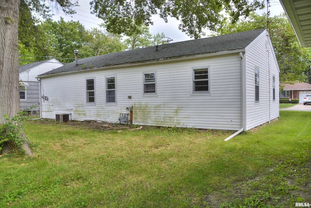 back of house featuring a lawn and central AC unit