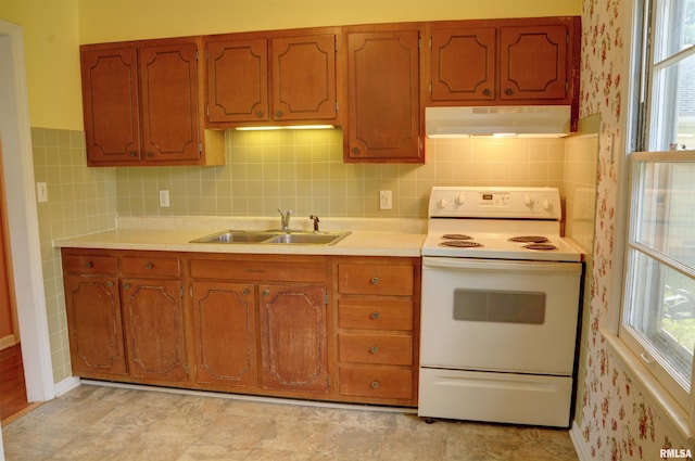 kitchen featuring white range with electric cooktop, light tile patterned floors, sink, and backsplash