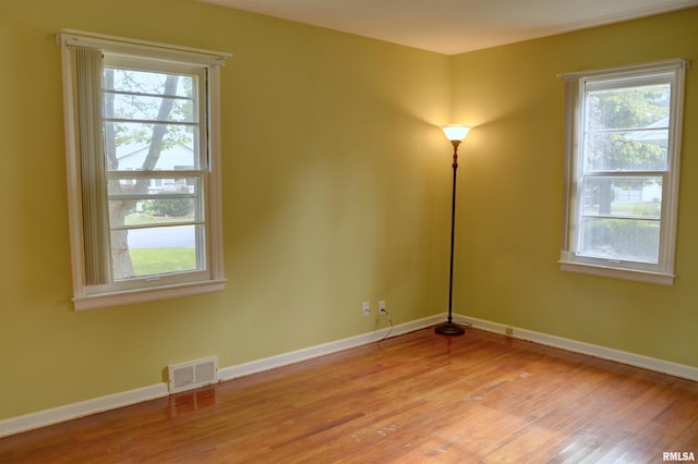 empty room with light hardwood / wood-style flooring