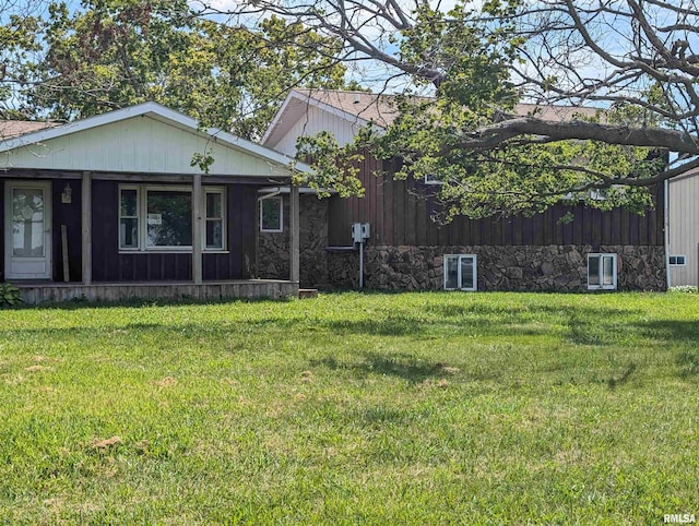 view of front of property with a front lawn and central air condition unit