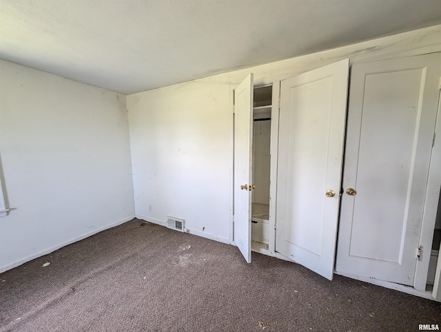 unfurnished bedroom featuring dark carpet