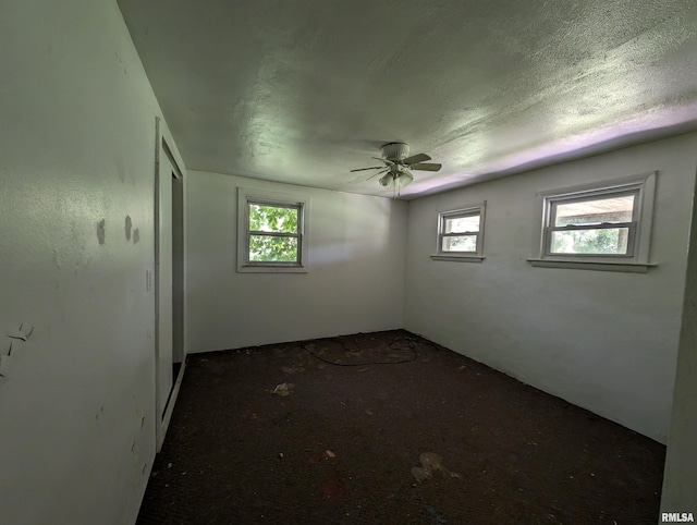 spare room with ceiling fan and a healthy amount of sunlight