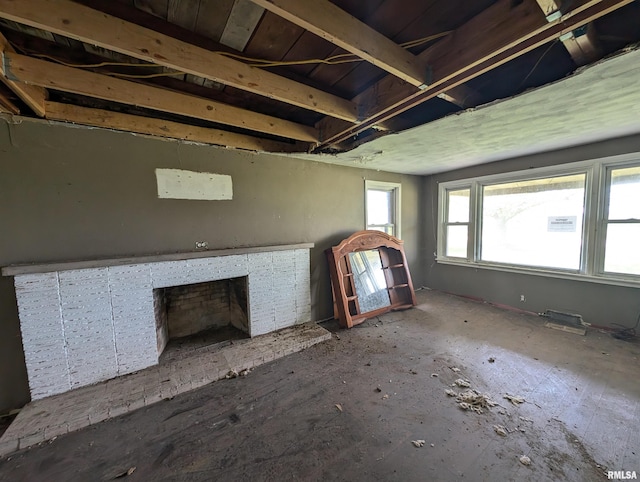 unfurnished living room featuring a brick fireplace