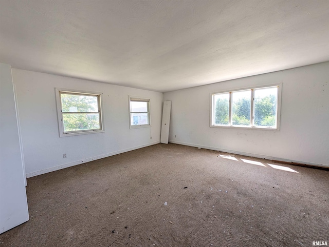 unfurnished room featuring dark carpet