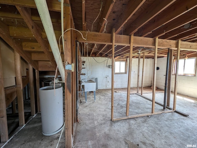 basement featuring gas water heater and sink