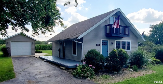 view of front of home with a garage and an outdoor structure