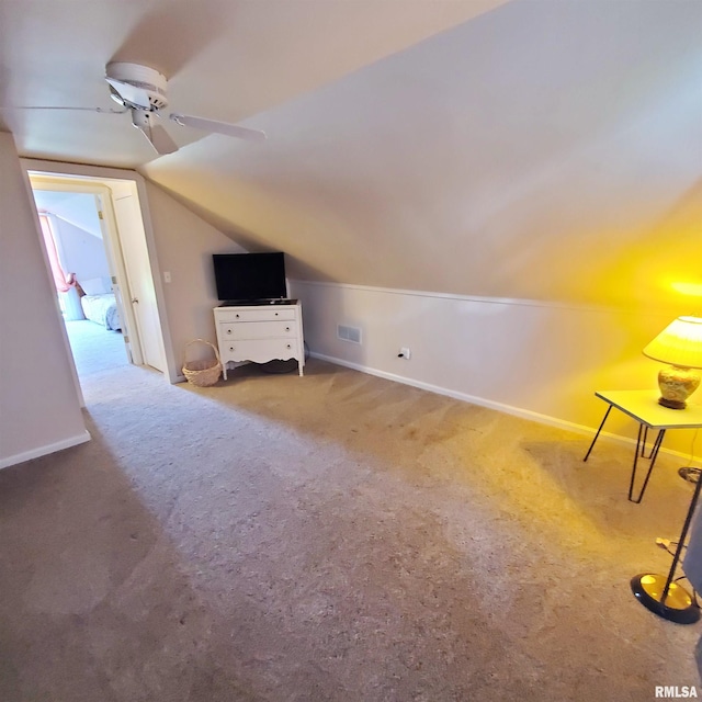 additional living space with vaulted ceiling, carpet floors, and ceiling fan