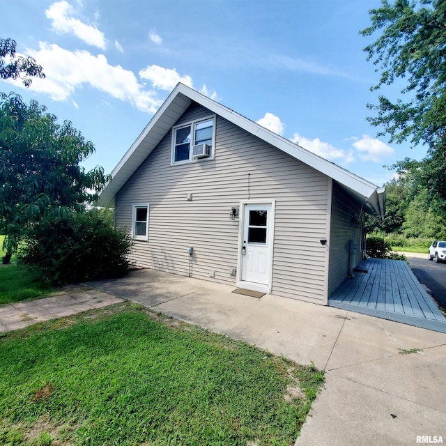 back of property featuring cooling unit, a yard, and a patio